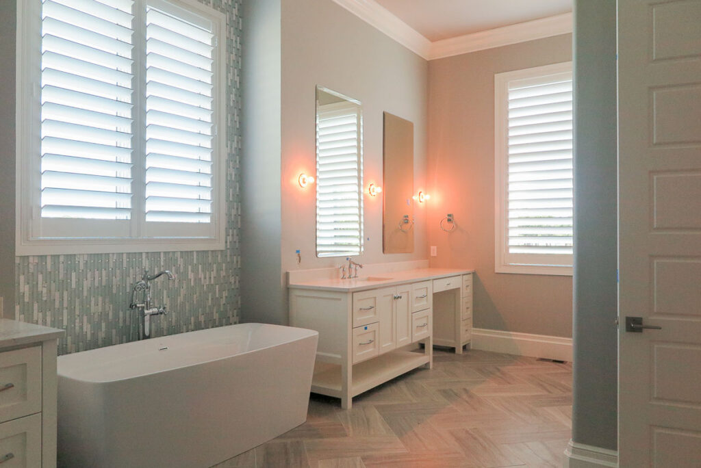 A cozy bathroom with a tub and a sink, perfect for a relaxing bath or getting ready in the morning with custom privacy window treatments