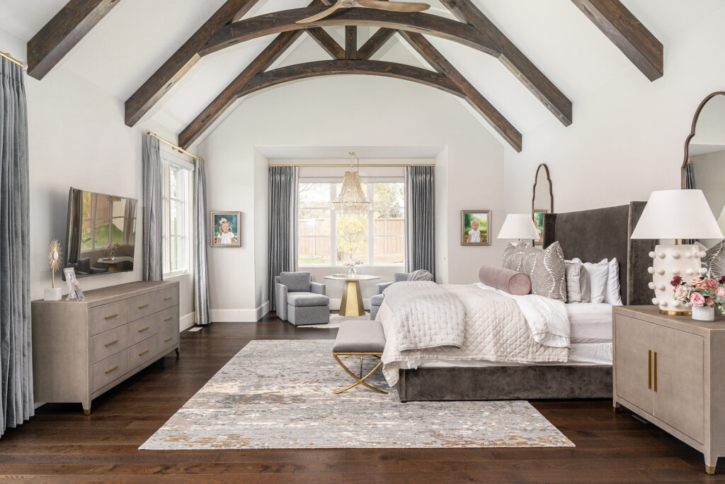 Charming bedroom with vaulted ceiling, custom window shades and drapes with vaulted ceiling wooden beams, perfect for a cozy retreat.