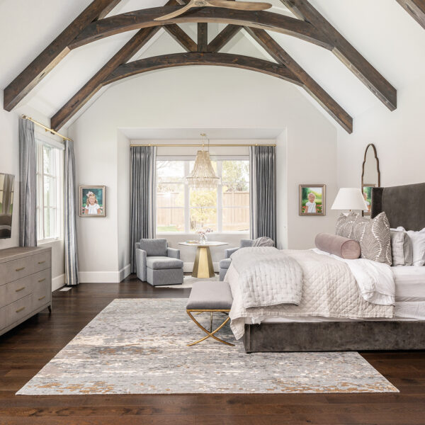 Charming bedroom with vaulted ceiling, custom window shades and drapes with vaulted ceiling wooden beams, perfect for a cozy retreat.