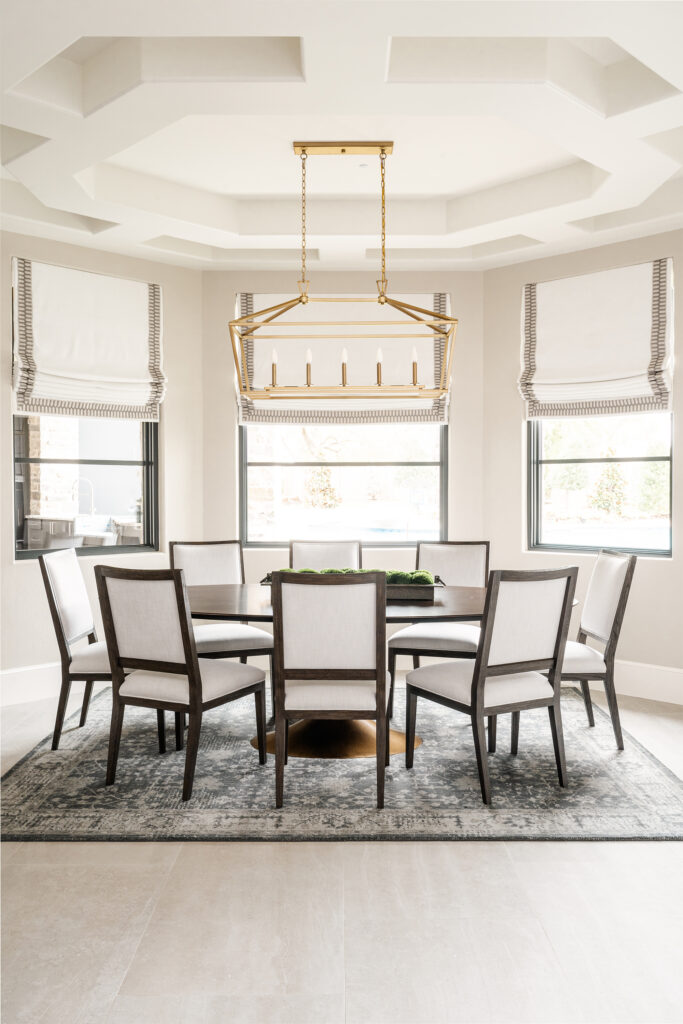 Contemporary luxury casual dining area with custom window treatments a sleek modern classic dining table and plush chairs, perfect for a relaxed yet upscale dining experience.