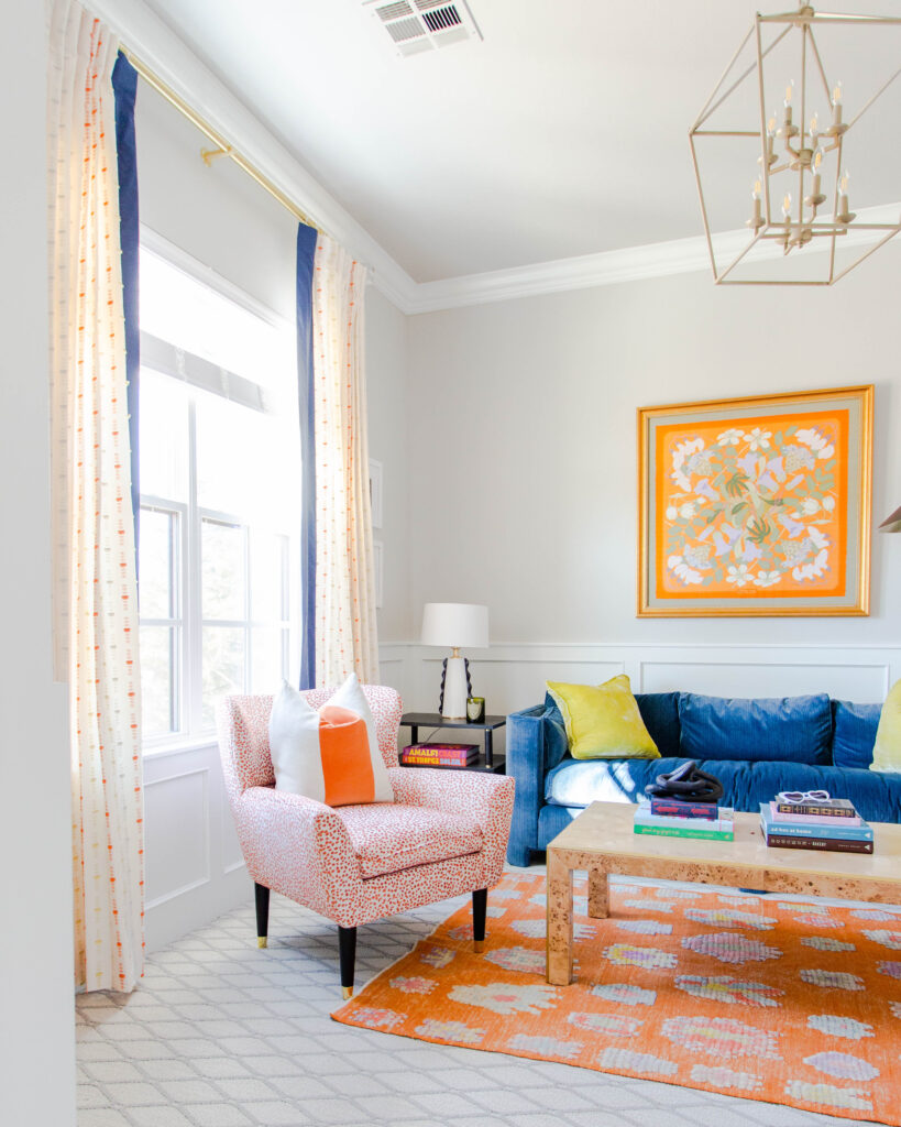 A modern living room decorated with eye-catching orange and blue furniture.