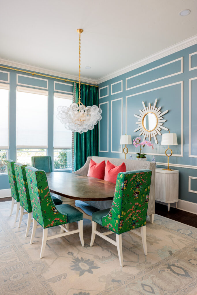 Relaxing dining room ambiance with blue walls and stylish green chairs and color complimenting custom drapery.